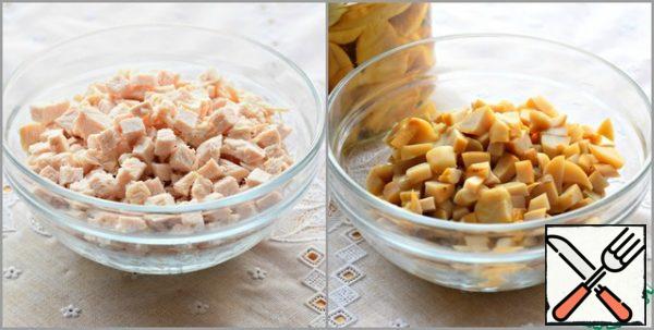 Boiled turkey (or chicken) breast cut into small pieces.
Canned mushrooms (I cook with pickled porcini mushrooms) are also cut into small cubes.