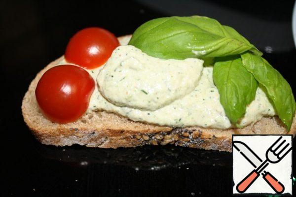 Very tasty pate on a piece of bread with herbs and vegetables.