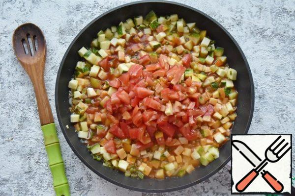 Cut the tomatoes into cubes and add them to the vegetables. Stir the tomato paste in 0.5 cups of water and pour it into the vegetable stew. Add salt, pepper, and spices to taste (paprika, basil, thyme, oregano).