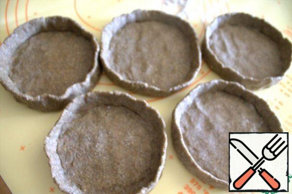 Roll each one into a ball and flatten it into a basket with sides. Ideally, you should not try, the sides are needed so that the filling does not leak out.