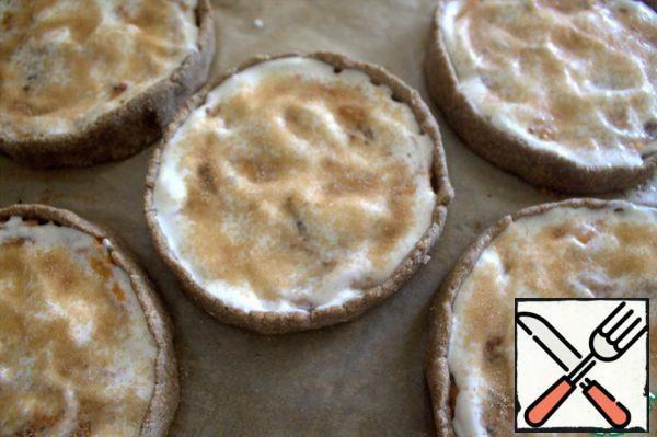 Top with sugar and cinnamon and put it back in the oven until it is browned.