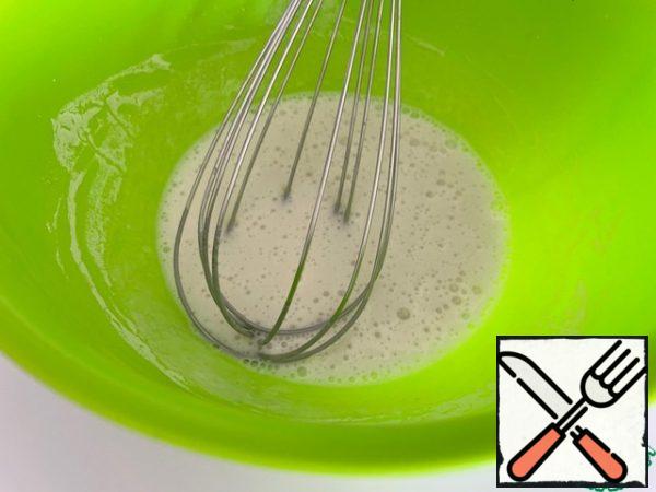 Pour warm water into the dough bowl, add sugar and yeast, pour out 0.5 cups of flour. Mix with a whisk and leave for 10 minutes. It should foam up.