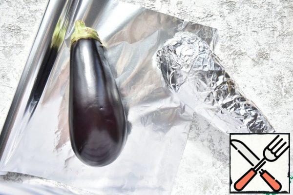 Wash the eggplants and wrap them in foil. Bake in the oven, preheated to 180 degrees until ready.