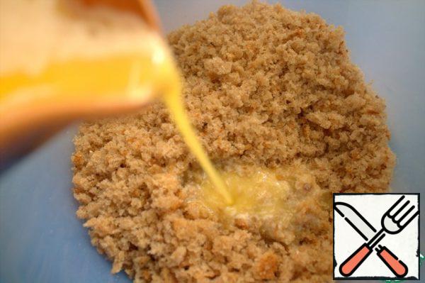 Pour the melted butter into the breadcrumbs.
