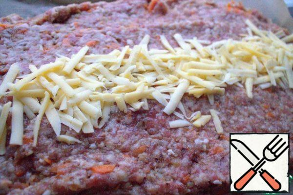 In the center, pour grated or chopped cheese along the entire length.