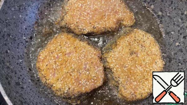 Fry the meat on both sides in vegetable oil until golden brown.