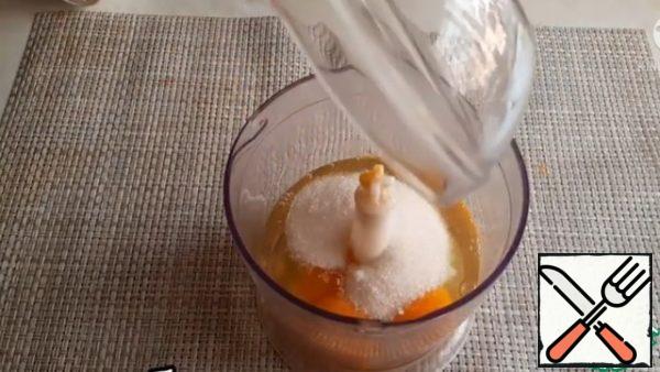 We punch eggs with sugar in a blender.