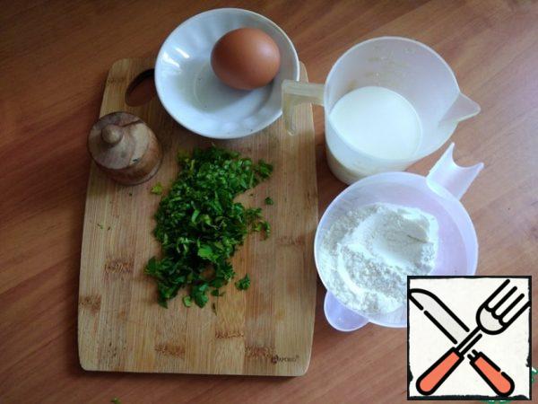 We prepare everything for pancakes. Finely chop the parsley. The milk should be warm.