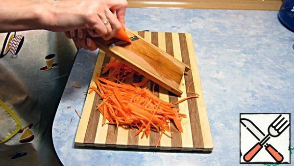 While the marinade is cooling, grate the carrots.