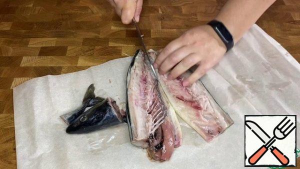 Cut off the head and tail of the mackerel. Make two longitudinal incisions along the back. Remove the spine and entrails. Divide into two fillets.