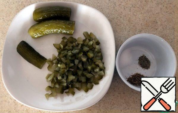 Finely crumble the pickled cucumbers.