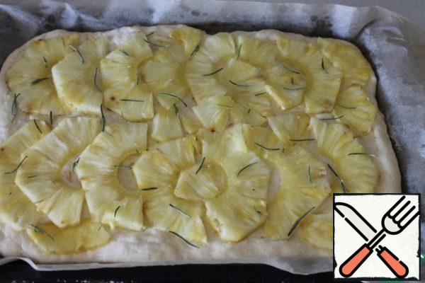 Put the pineapple in half rings on the dough that has come up for the second time, slightly pressing it. Spread the rosemary on top. Place in a preheated 200 degree oven for 15-20 minutes. The main thing is not to over-dry!!! (as I did...)