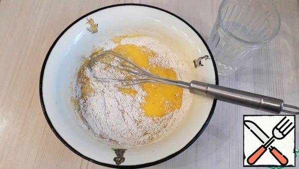 Add 1/3 cup of mineral water. Beat the mixture well again with a whisk.