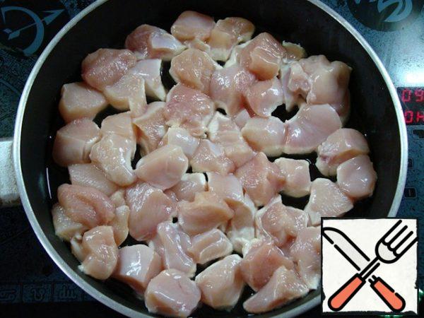 Cut the chicken fillet into large pieces and fry until tender.
