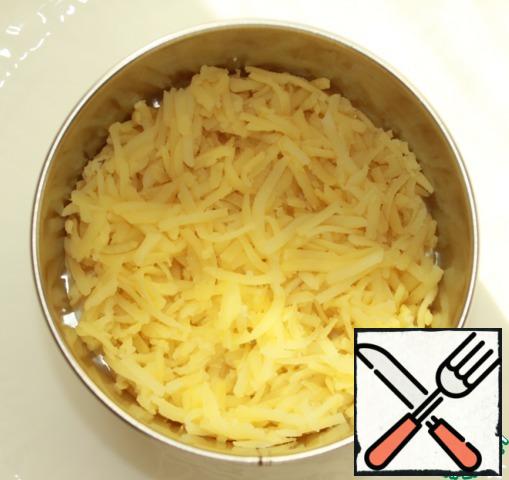 The first layer is boiled potatoes grated on a medium grater + salt to taste.