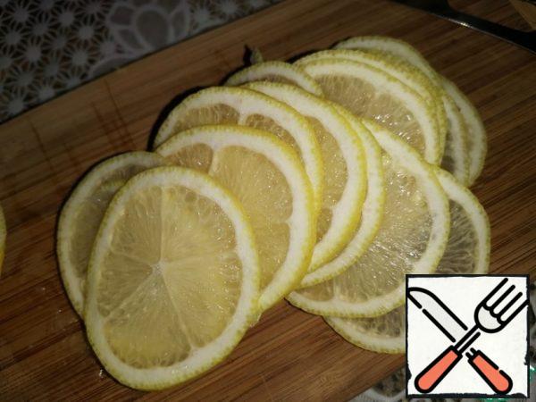 Wash the lemon thoroughly and wipe it dry.
I had a large lemon, so I cut one half into thin circles, and grated the zest on the other half.