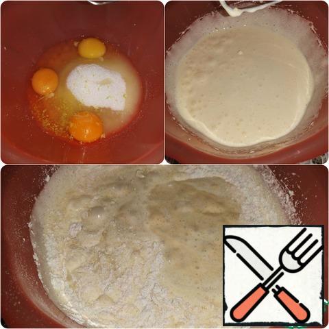 Beat eggs with sugar until fluffy white mass.
Add lemon zest, sour cream, flour mixture and mix the dough quickly.