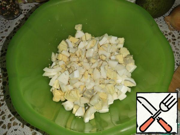 Boil the eggs and cut into medium-sized cubes.