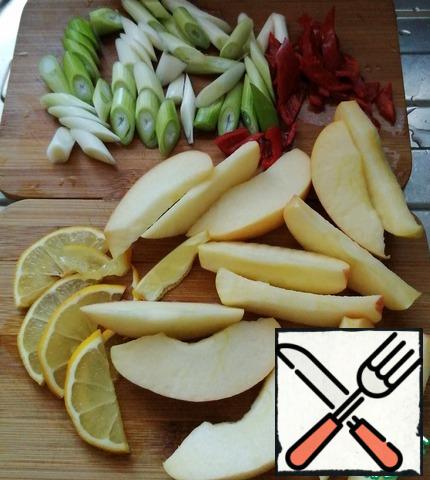 Cut the onion into large pieces diagonally. Lemon and apples into slices.