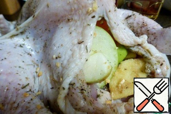 Fill the belly of the chicken with fruit, but do not stuff tightly.