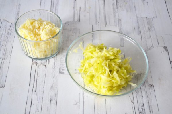 Wash, dry, and peel the medium-sized apple. Grate it on a coarse grater. Grate the hard cheese on a medium-sized grater. Place all ingredients in separate containers.

