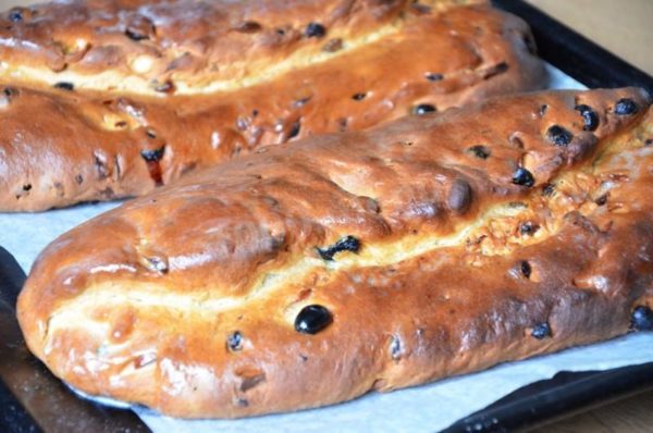 While the stollens are still hot, generously brush them with melted butter and dust with powdered sugar. Allow them to cool completely.


