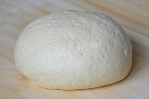 Knead the dough thoroughly for 7-10 minutes. Place the kneaded dough in a bowl, cover it with a napkin, and let it rise for 1-1.5 hours until it doubles in volume.


