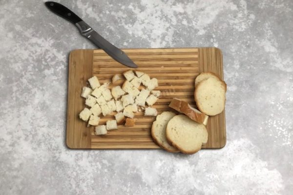Cut the loaf into small, bite-sized cubes.

