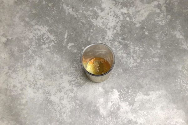 In a whipping glass, crack the prepared egg and add parmesan, mustard, sugar, salt, oil, and chopped garlic.


