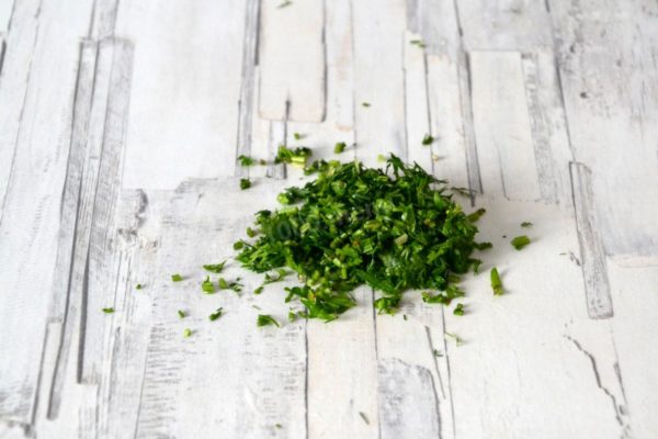 Wash the greens, dry them, and finely chop.


