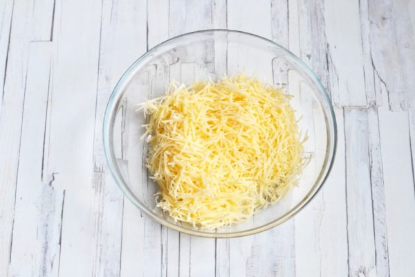 Grate the cheese using a medium grater.


