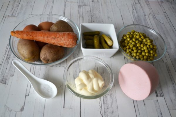 Begin by gathering the essential ingredients for crafting a delicious olivier with sausage. Pre-boil and cool the potatoes and carrots. Also, hard-boil the chicken eggs, allow them to cool, and peel off the shells. Choose any boiled sausage according to your taste preference. Whether the cucumbers are salted or pickled is not critical.


