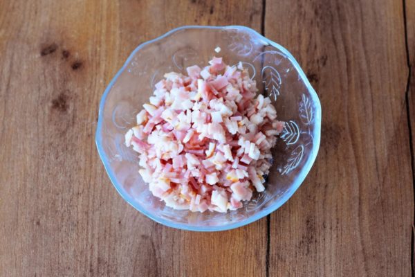 Cut the bacon into small pieces, opting for smoked or boiled bacon based on your preference.


