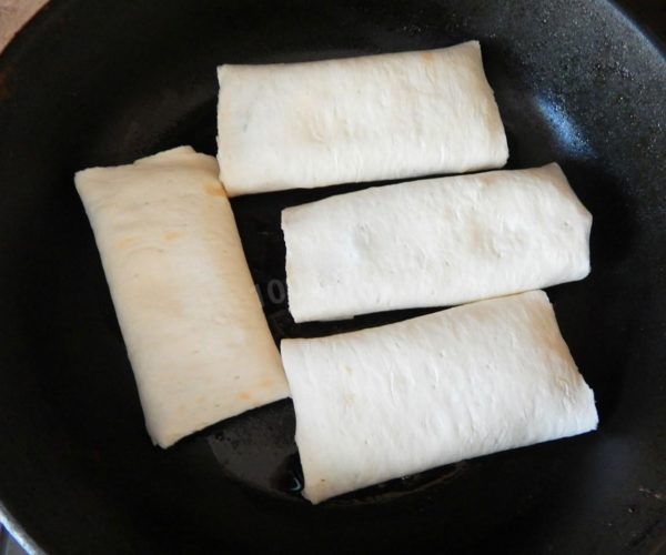 Heat vegetable oil in a frying pan and add the pita bread envelopes. Fry for five minutes on both sides until the cheese inside melts, and the top of the pita bread achieves a slight golden brown color.

