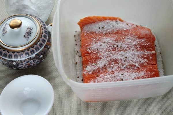 Place the fillets skin-side down on a layer of the salt mixture, ensuring an even coating on all sides.


