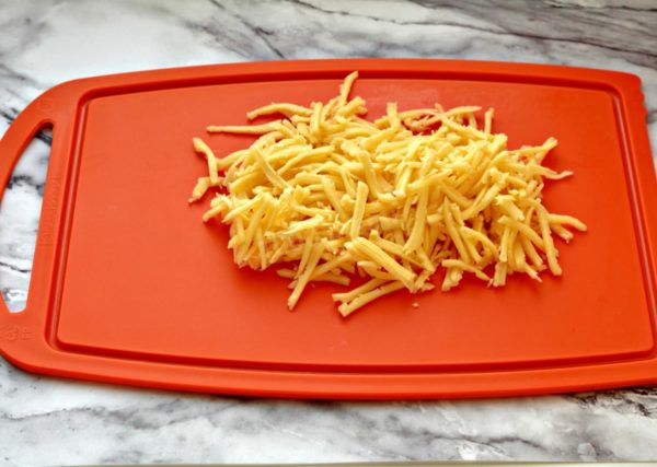 Choose any firm cheese you prefer; salty cheese works well. Grate the hard cheese using a coarse grater. Alternatively, you can cut the cheese into small cubes for a slightly different salad texture. I personally enjoy the taste with grated cheese.

