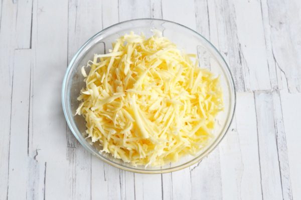 Grate the cheese on a coarse grater.


