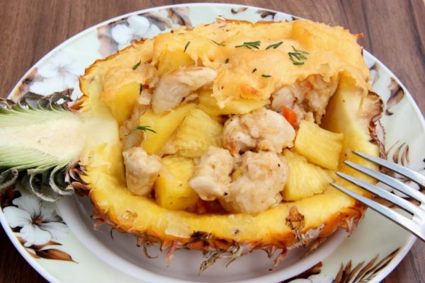 Serve the baked pineapple hot. This dish stands on its own, but you can garnish it with a touch of fresh herbs if desired. Enjoy your meal!

