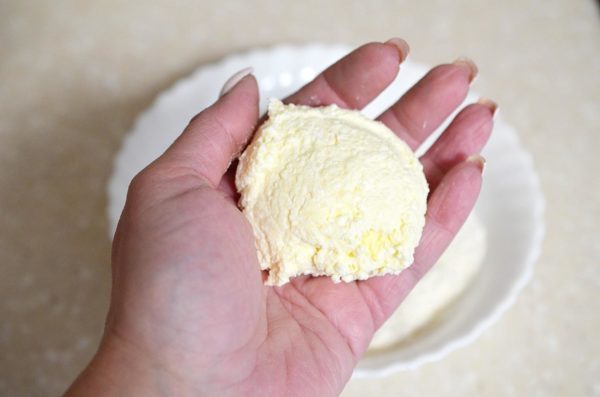 Take a portion of the dough and shape it into a small flat cake.


