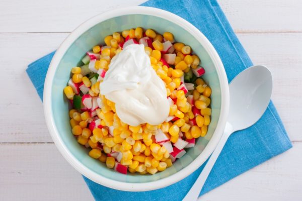 In a separate small container, combine equal proportions of sour cream and mayonnaise. Season the mixture with salt to taste, and you can add ground black pepper if desired. Use this sauce to dress the salad.


