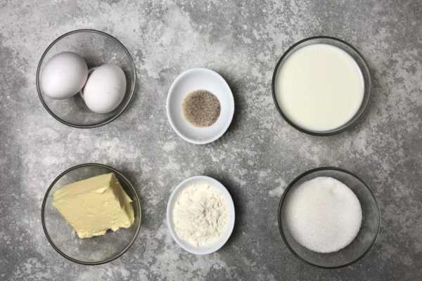How to prepare a traditional custard? Gather the ingredients you'll need. The amount of sugar provided is a moderate guideline; you can adjust it to your taste, ranging from 170 to 230 grams, depending on your preferences and what you intend to pair the custard with. Choose the highest quality butter for a thick and creamy result. This quantity of ingredients will yield enough custard for one cake, based on two eggs.


