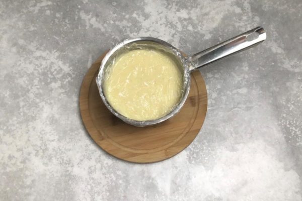 Let the custard cool to room temperature. It's essential to cover the custard with plastic wrap, ensuring it touches the surface directly. This prevents the formation of a thick crust on the custard as it cools. Refrigerate the custard for at least 2 hours to chill and thicken fully. If you plan to use the custard for a cake, you can spread it between the layers while it's still warm and then refrigerate the cake.
