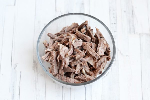 Allow the beef to cool, then separate the meat from the bones and cut it into strips.


