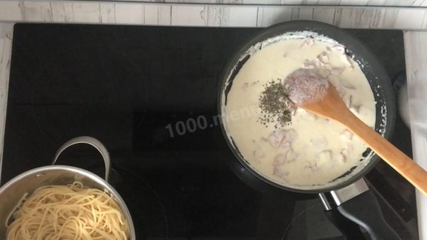 Seasoning the Sauce: Add Italian herbs, ground pepper, and salt to the sauce and mix well.


