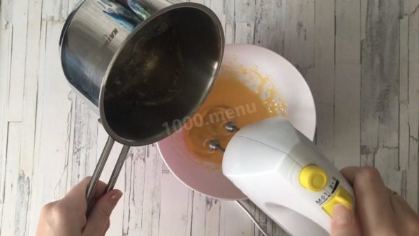 While the syrup is cooking, whisk the egg yolks until they become a light mixture. Continue to whisk while slowly pouring the hot sugar syrup into the yolks in a thin stream. Keep whisking until the mixture turns white.


