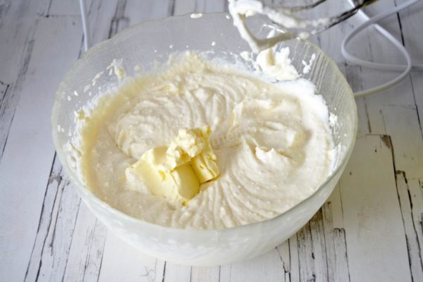 Incorporate the softened butter into the mixture. Beat it again until the mixture is smooth. Ensure that the butter is softened, not melted, to maintain the desired consistency of the cottage cheese dough.

