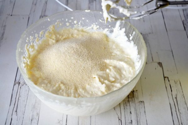 Gradually add the semolina while beating the mixture at a low speed with the mixer after each addition. If the cottage cheese you're using is particularly moist, you may need to increase the amount of semolina to prevent the dough from becoming too runny.

