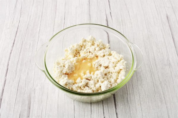 Beat an egg and add it to the cottage cheese mixture, ensuring thorough mixing.

