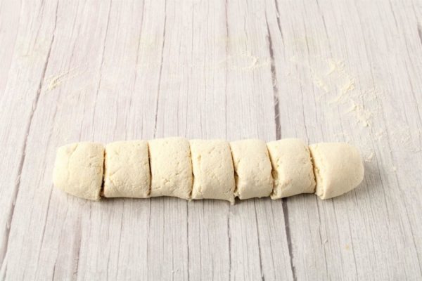Sprinkle a bit of flour on your work surface, then roll the dough into a sausage shape. Divide the dough into equal portions based on your desired pancake size.

