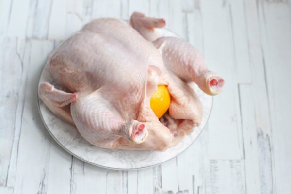 Place the whole lemon inside the prepared chicken. Optionally, you can season the inside of the chicken with salt and pepper before inserting the lemon.

